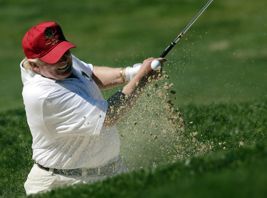 Donald Trump hits out of a sand trap on the 15th hole during a pro-am round of the AT&T National golf tournament at Congressional Country Club, Wednesday, June 27, 2012, in Bethesda, Md. (AP Photo/Patrick Semansky)