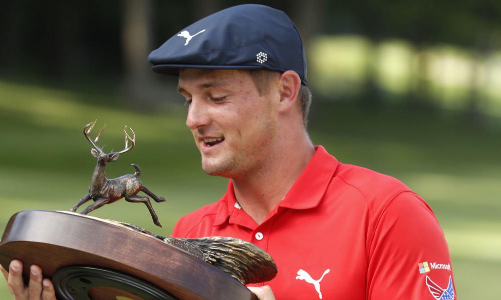 Bryson DeChambeau celebrates with the trophy after winning the John Deere Classic golf tournament, Sunday, July 16, 2017, at TPC Deere Run in Silvis, Ill. (AP Photo/Charlie Neibergall)