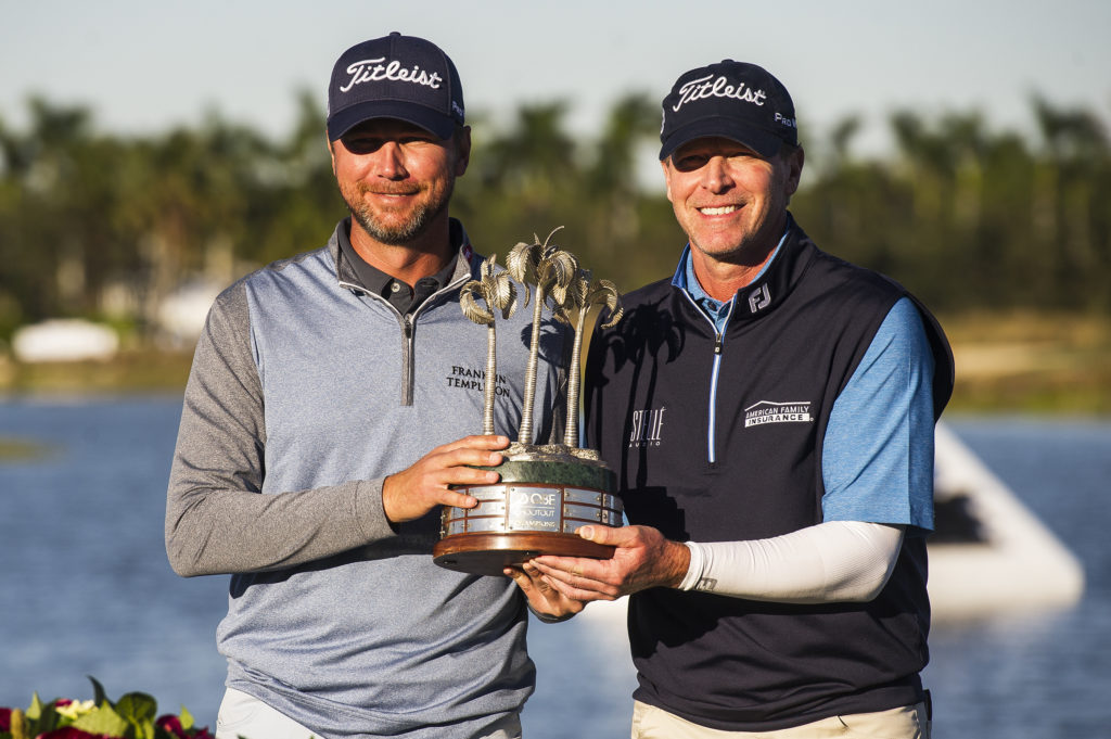 Sean O'Hair, left, and Steve Stricker hold up their trophy after winning the final round of the QBE Shootout golf tournament at Tiburón Gulf Club in Naples, Fla., Sunday, Dec. 10, 2017. (Logan Newell/Naples Daily News via AP)