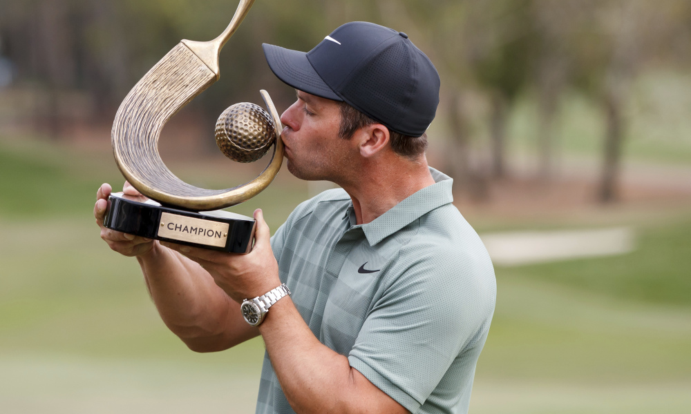 Paul Casey kisses the champion's trophy after winning the Valspar Championship golf tournament Sunday, March 11, 2018, in Palm Harbor, Fla. (AP Photo/Mike Carlson)